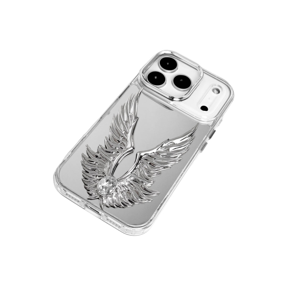The Gem Silver Angel Wings iPhone Case featuring symmetrical 3D sculpted silver wings with a central rhinestone. Shown with both White and Black gem options, available on Silver, Transparent, and Black case bases.