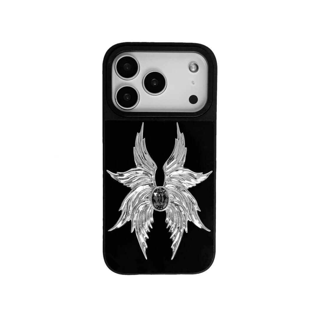 The Gem Silver Seraphim iPhone Case featuring 3D sculpted silver metallic wings with a central rhinestone. Shown with both White and Black gem options, available on Silver, Transparent, and Black case bases.