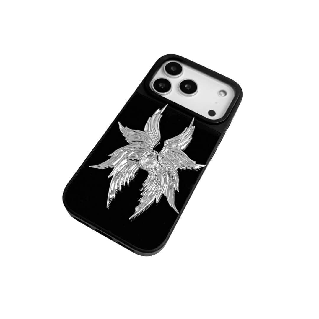 The Gem Silver Seraphim iPhone Case featuring 3D sculpted silver metallic wings with a central rhinestone. Shown with both White and Black gem options, available on Silver, Transparent, and Black case bases.