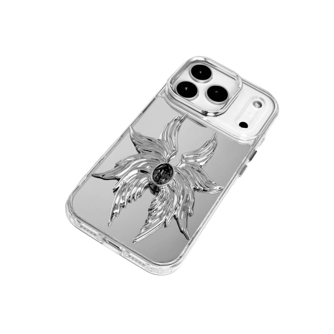 The Gem Silver Seraphim iPhone Case featuring 3D sculpted silver metallic wings with a central rhinestone. Shown with both White and Black gem options, available on Silver, Transparent, and Black case bases.