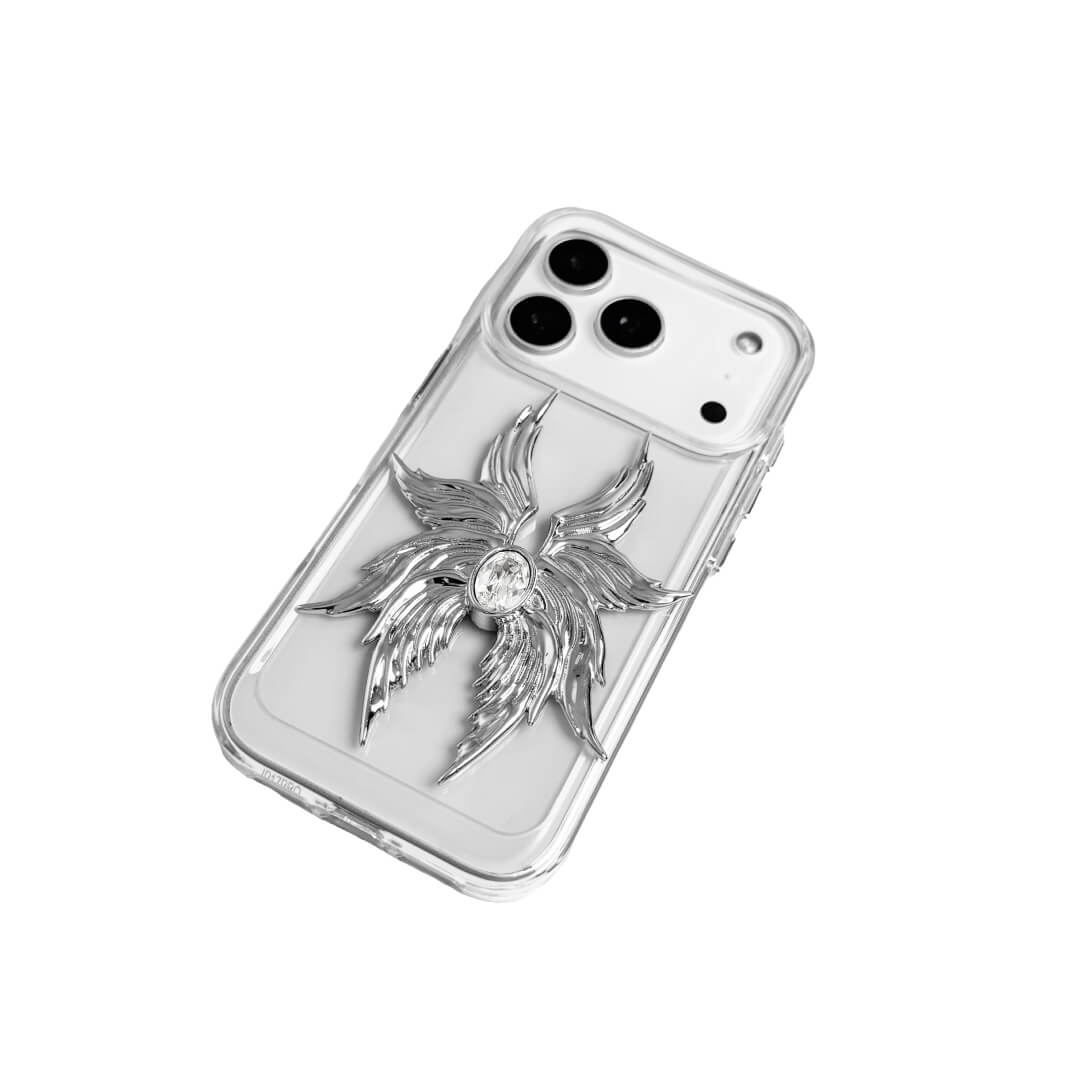 The Gem Silver Seraphim iPhone Case featuring 3D sculpted silver metallic wings with a central rhinestone. Shown with both White and Black gem options, available on Silver, Transparent, and Black case bases.