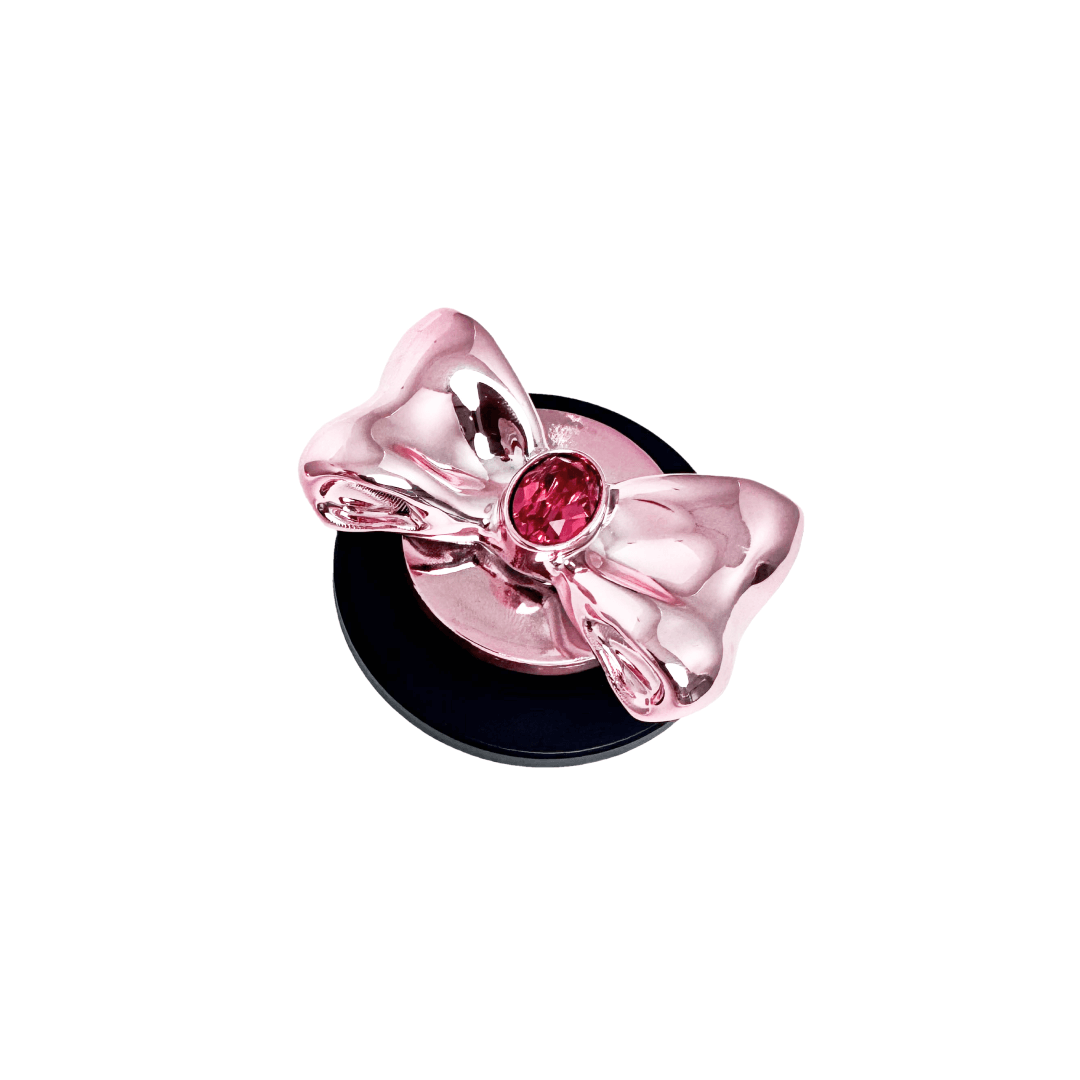 Gem Bow Phone Grip S available in silver, pink, black, and white bows, each featuring Swarovski crystal options: silver with pink, purple, white, blue, or black gems; pink with pink gem; black and white with black, white, or pink gems.