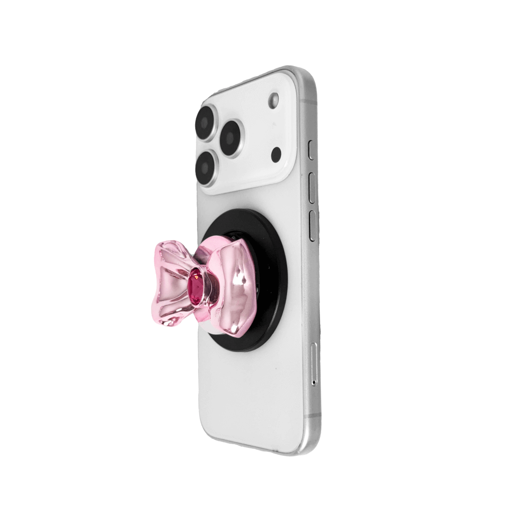 Gem Bow Phone Grip S available in silver, pink, black, and white bows, each featuring Swarovski crystal options: silver with pink, purple, white, blue, or black gems; pink with pink gem; black and white with black, white, or pink gems.