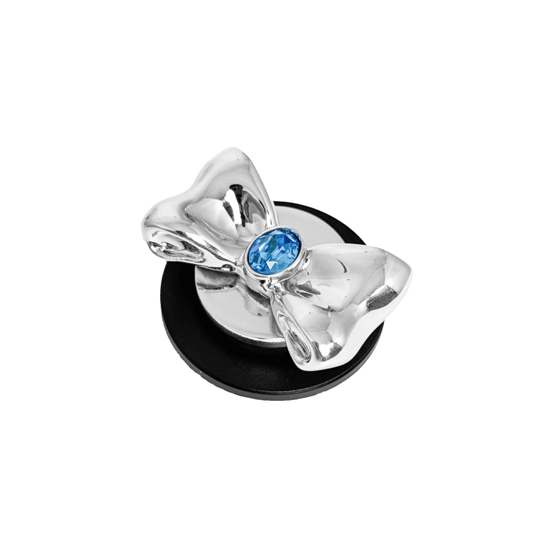 Gem Bow Phone Grip S available in silver, pink, black, and white bows, each featuring Swarovski crystal options: silver with pink, purple, white, blue, or black gems; pink with pink gem; black and white with black, white, or pink gems.