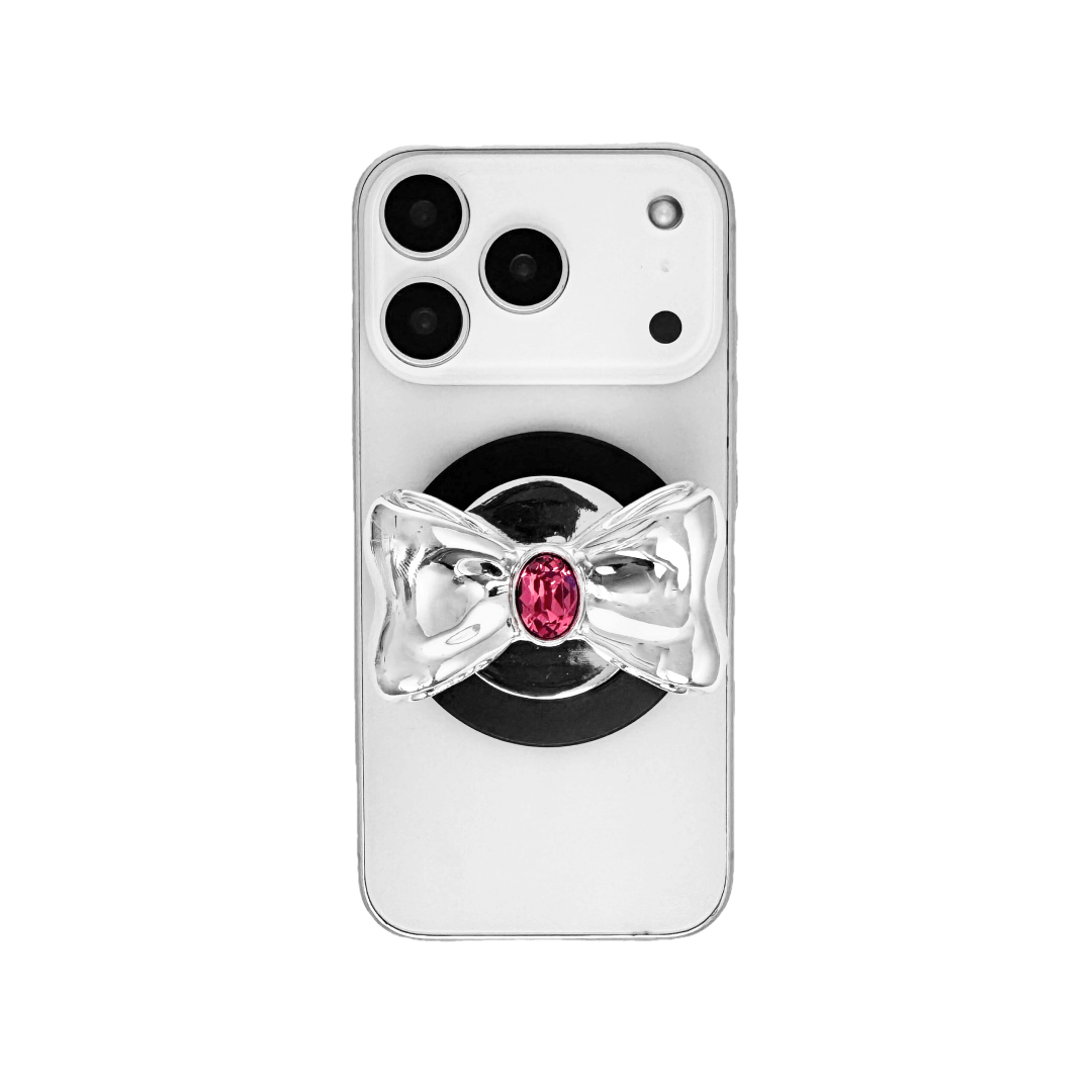 Gem Bow Phone Grip S available in silver, pink, black, and white bows, each featuring Swarovski crystal options: silver with pink, purple, white, blue, or black gems; pink with pink gem; black and white with black, white, or pink gems.