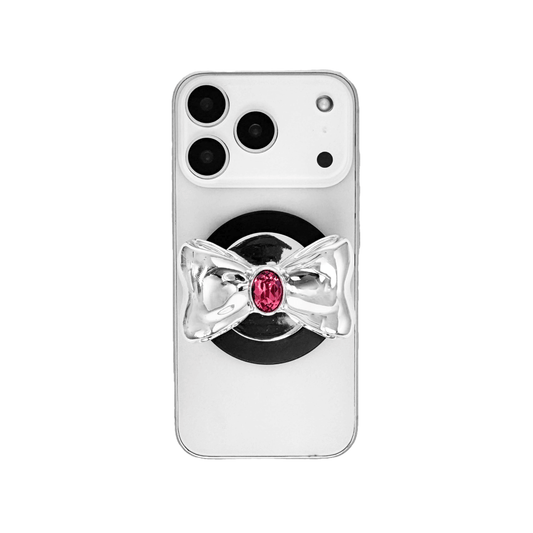 Gem Bow Phone Grip S available in silver, pink, black, and white bows, each featuring Swarovski crystal options: silver with pink, purple, white, blue, or black gems; pink with pink gem; black and white with black, white, or pink gems.