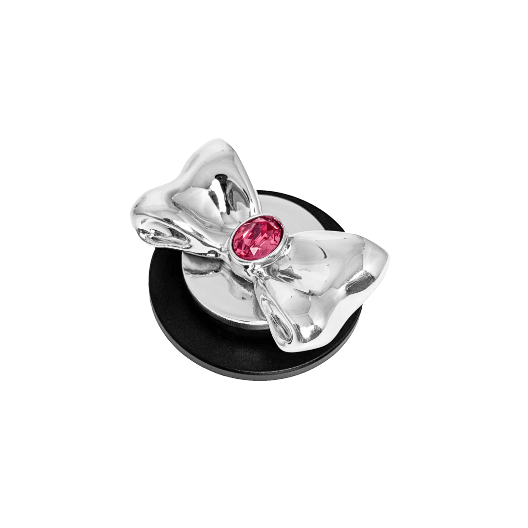 Gem Bow Phone Grip S available in silver, pink, black, and white bows, each featuring Swarovski crystal options: silver with pink, purple, white, blue, or black gems; pink with pink gem; black and white with black, white, or pink gems.