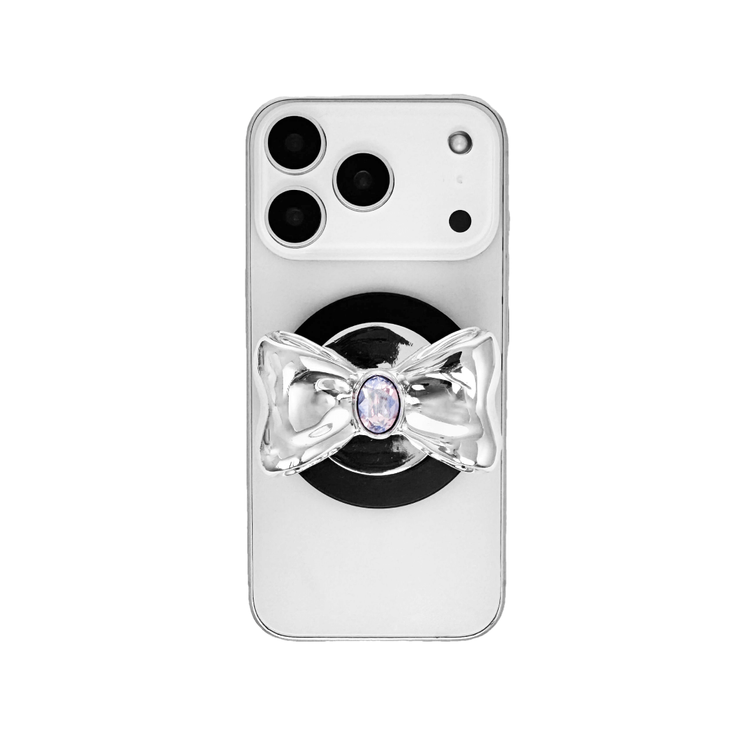 Gem Bow Phone Grip S available in silver, pink, black, and white bows, each featuring Swarovski crystal options: silver with pink, purple, white, blue, or black gems; pink with pink gem; black and white with black, white, or pink gems.