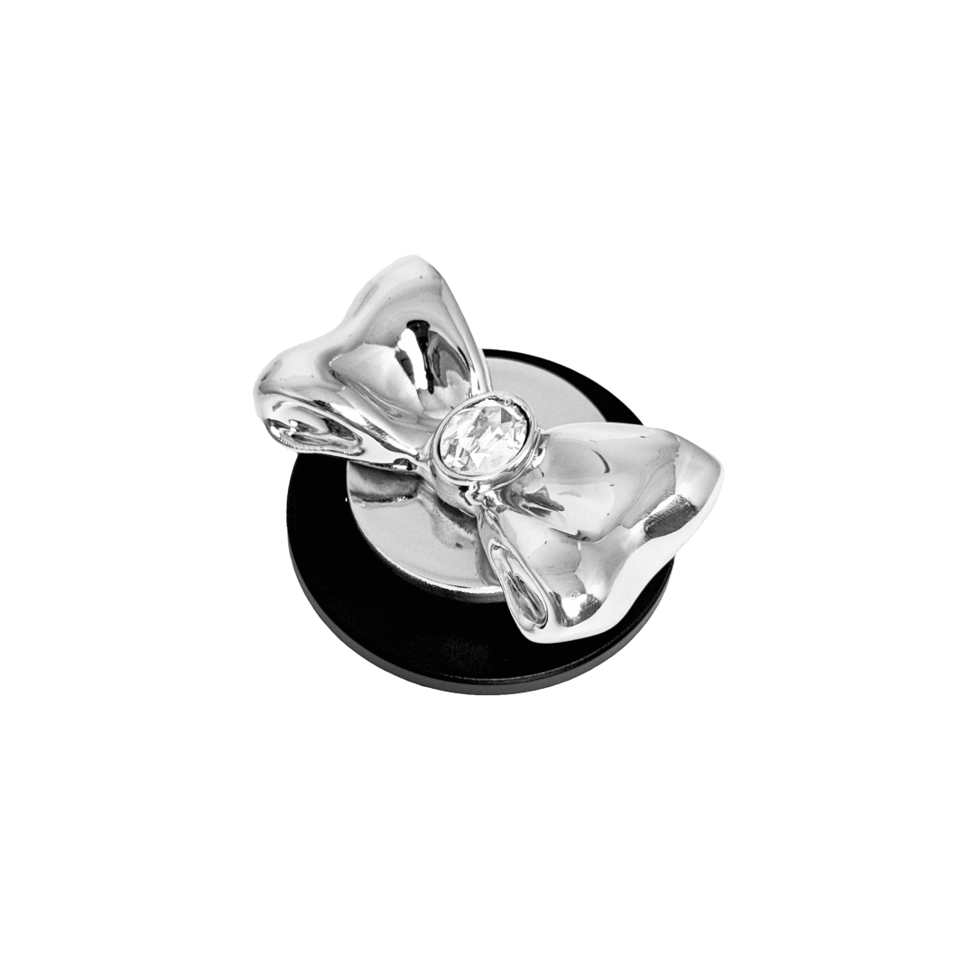 Gem Bow Phone Grip S available in silver, pink, black, and white bows, each featuring Swarovski crystal options: silver with pink, purple, white, blue, or black gems; pink with pink gem; black and white with black, white, or pink gems.