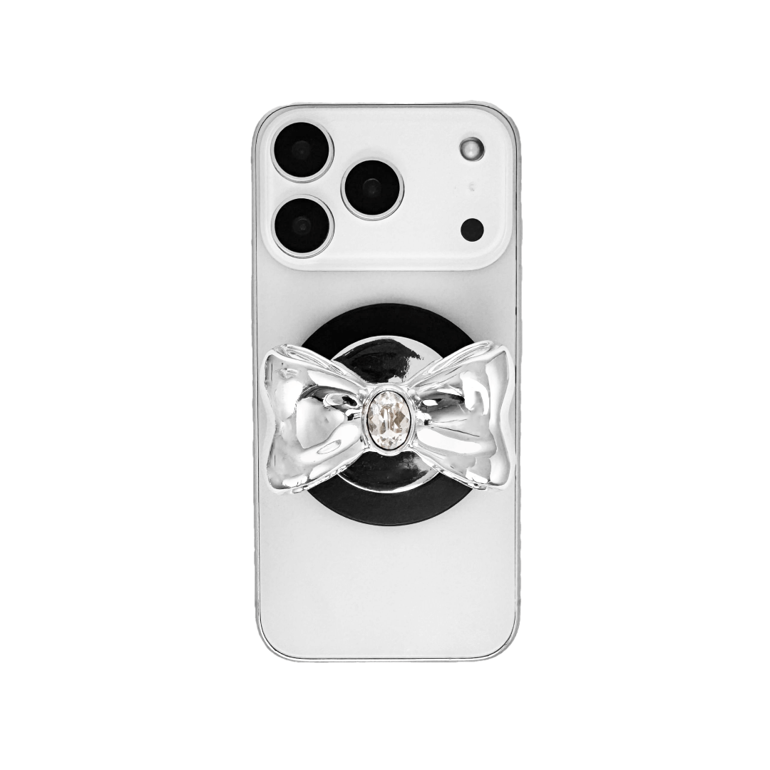 Gem Bow Phone Grip S available in silver, pink, black, and white bows, each featuring Swarovski crystal options: silver with pink, purple, white, blue, or black gems; pink with pink gem; black and white with black, white, or pink gems.