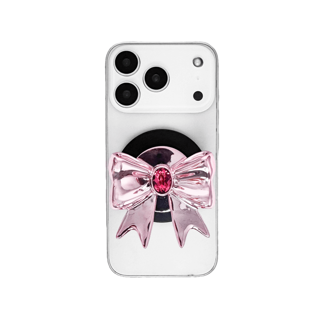 Gem Ribbon Phone Grip S available in silver, pink, black, and white ribbon designs, each featuring Swarovski crystal options: silver with pink, purple, white, blue, or black gems; pink with pink gem; black and white with black, white, or pink gems.