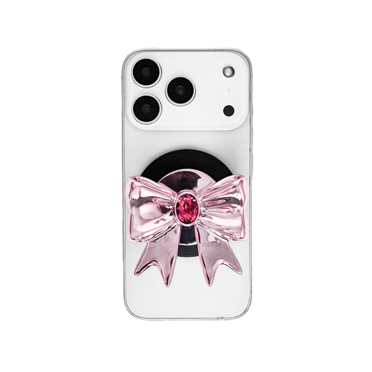 Gem Ribbon Phone Grip S available in silver, pink, black, and white ribbon designs, each featuring Swarovski crystal options: silver with pink, purple, white, blue, or black gems; pink with pink gem; black and white with black, white, or pink gems.