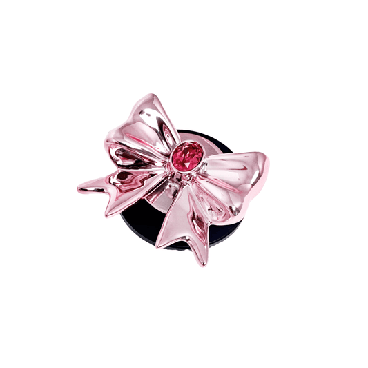 Gem Ribbon Phone Grip S available in silver, pink, black, and white ribbon designs, each featuring Swarovski crystal options: silver with pink, purple, white, blue, or black gems; pink with pink gem; black and white with black, white, or pink gems.