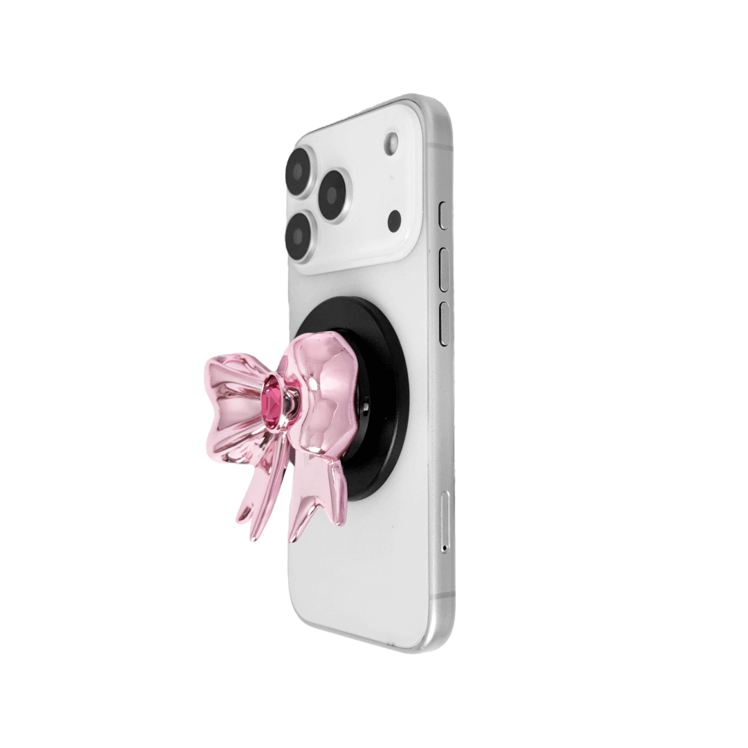 Gem Ribbon Phone Grip S available in silver, pink, black, and white ribbon designs, each featuring Swarovski crystal options: silver with pink, purple, white, blue, or black gems; pink with pink gem; black and white with black, white, or pink gems.