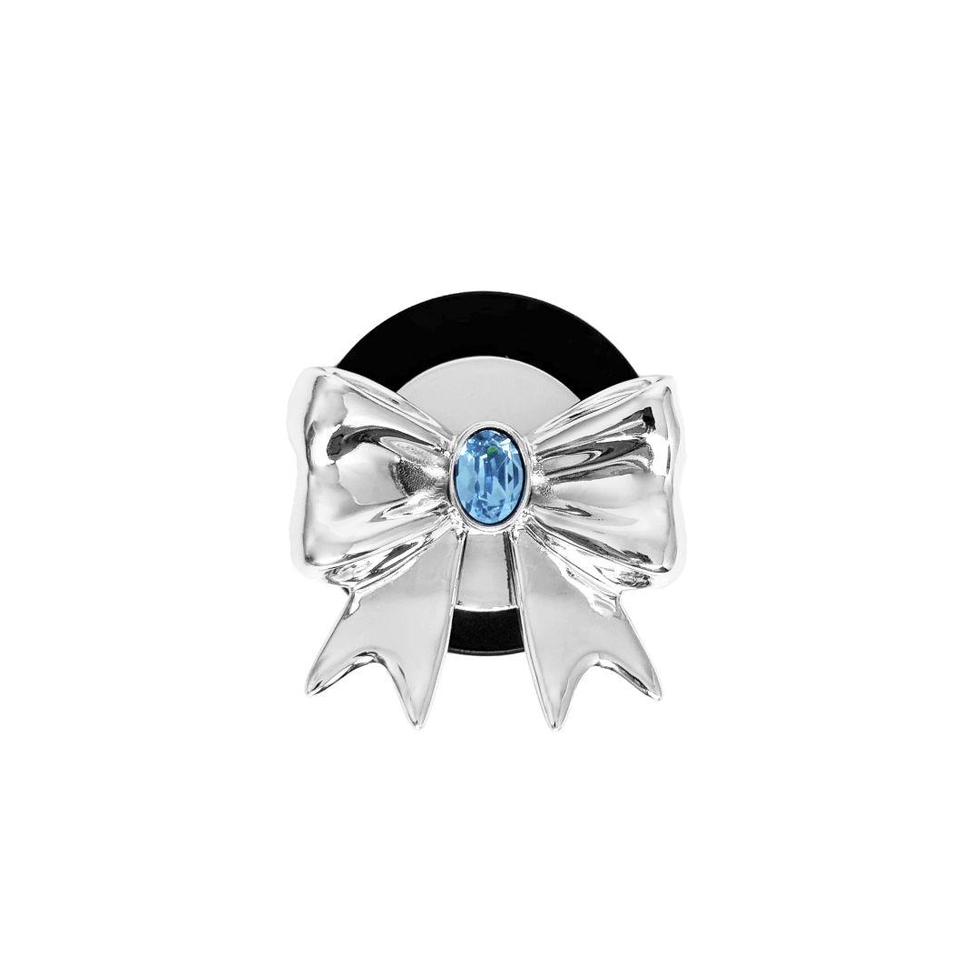 Gem Ribbon Phone Grip S available in silver, pink, black, and white ribbon designs, each featuring Swarovski crystal options: silver with pink, purple, white, blue, or black gems; pink with pink gem; black and white with black, white, or pink gems.