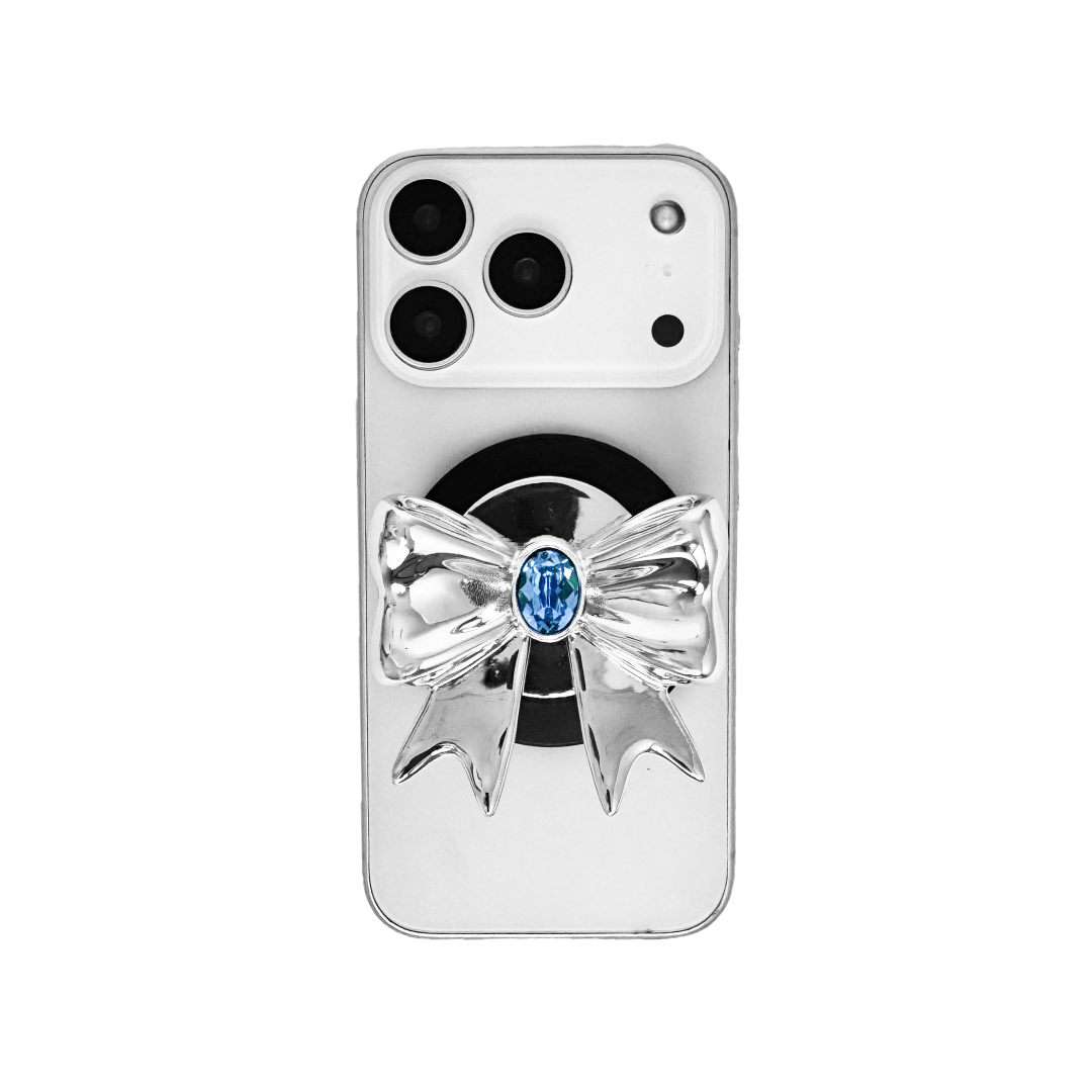 Gem Ribbon Phone Grip S available in silver, pink, black, and white ribbon designs, each featuring Swarovski crystal options: silver with pink, purple, white, blue, or black gems; pink with pink gem; black and white with black, white, or pink gems.