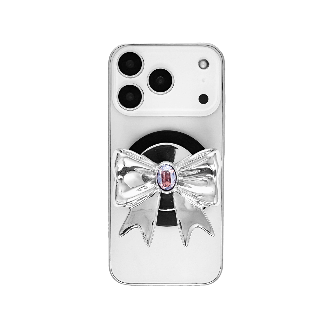 Gem Ribbon Phone Grip S available in silver, pink, black, and white ribbon designs, each featuring Swarovski crystal options: silver with pink, purple, white, blue, or black gems; pink with pink gem; black and white with black, white, or pink gems.