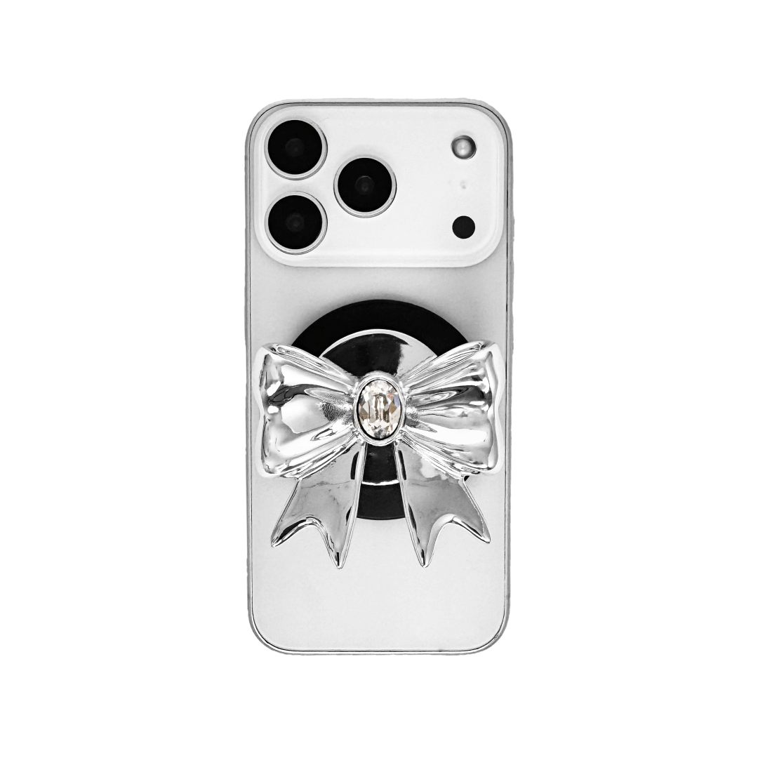 Gem Ribbon Phone Grip S available in silver, pink, black, and white ribbon designs, each featuring Swarovski crystal options: silver with pink, purple, white, blue, or black gems; pink with pink gem; black and white with black, white, or pink gems.
