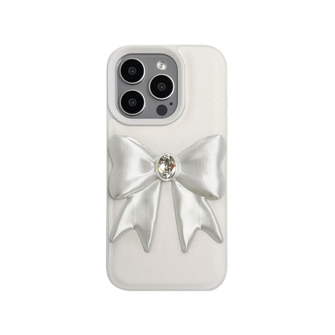 The Glossy White Gem Bow iPhone Case featuring the stunning 3D sculpted white bow with a central gem embellishment, shown on both the Crystal Clear (Transparent) and White Leather Texture base options.