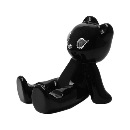 The Sculpted Gummy Bear Phone Stand collection, featuring substantial 3D bear figurines in both reflective Silver Chrome and sleek Glossy Black finishes. Designed as desktop holders to securely support mobile devices in both portrait and landscape orientations.