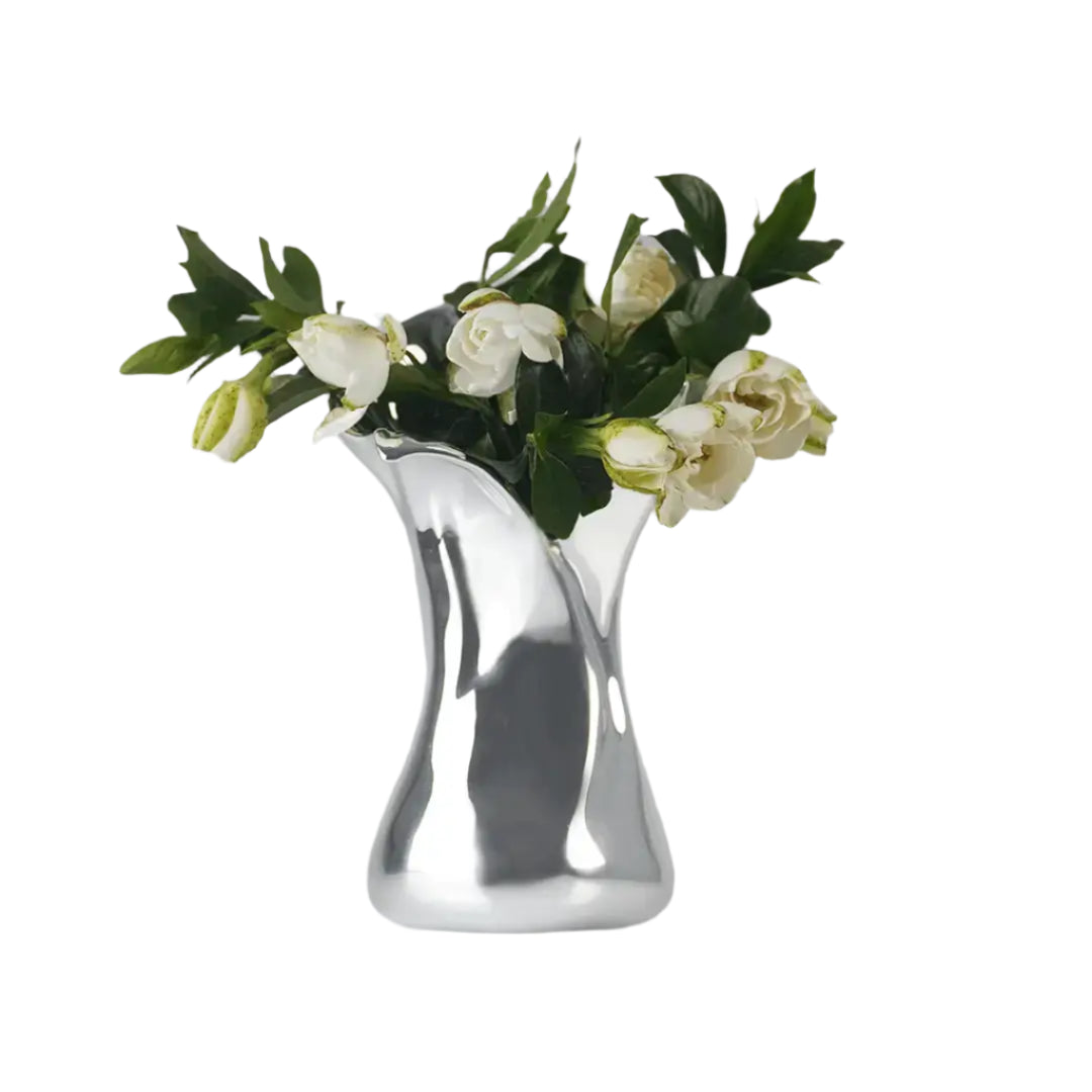 Futuristic chrome vase with flowing sculptural petal design – organic metallic form inspired by blooming lilies