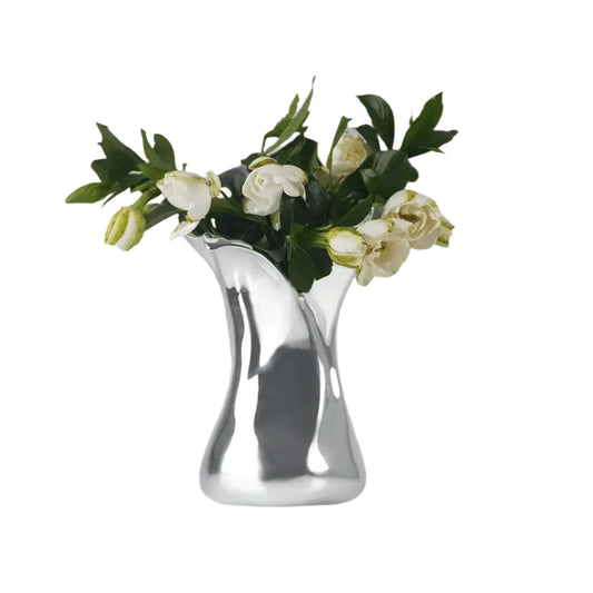 Futuristic chrome vase with flowing sculptural petal design – organic metallic form inspired by blooming lilies