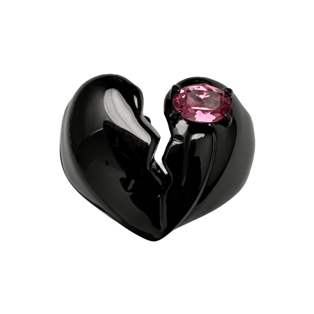 Wide band ring with a broken heart design and a pink Swarovski crystal centerpiece.