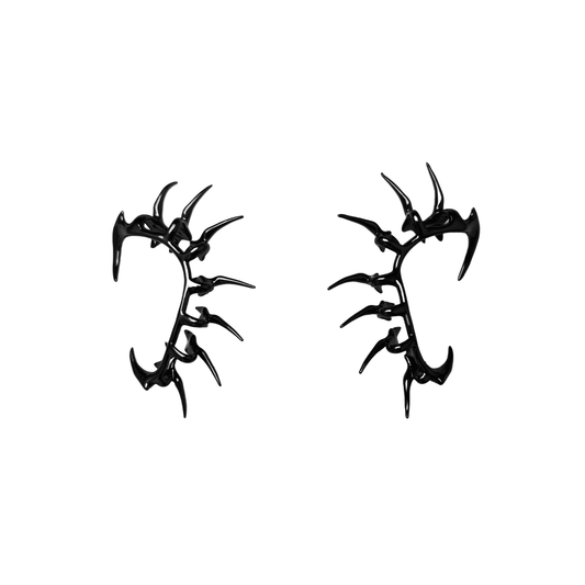 Horn Ear Cuffs — spiked ear cuffs featuring a curved horn-like silhouette, available in black and silver, blending mythic edge with modern minimalism.