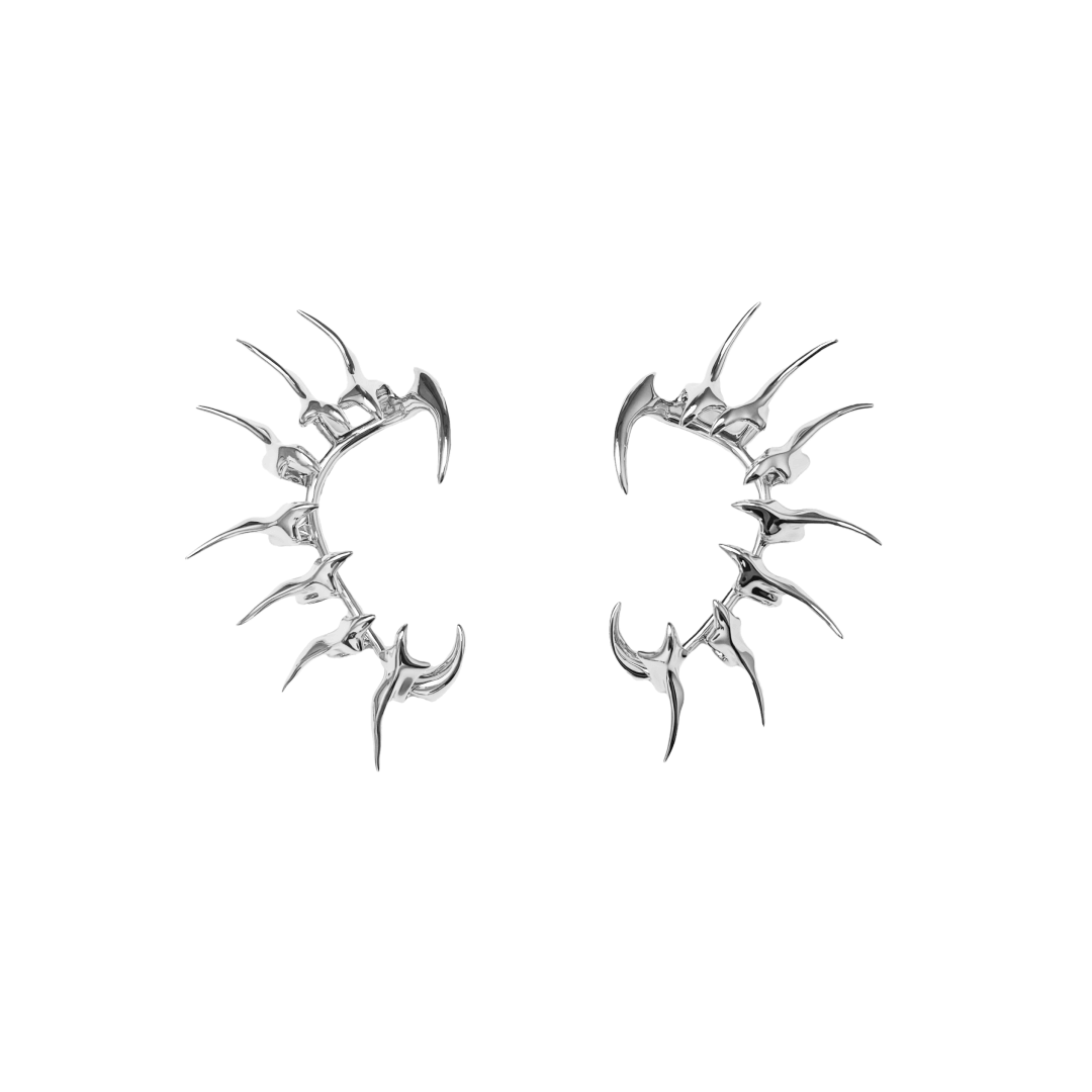 Horn Ear Cuffs — spiked ear cuffs featuring a curved horn-like silhouette, available in black and silver, blending mythic edge with modern minimalism.