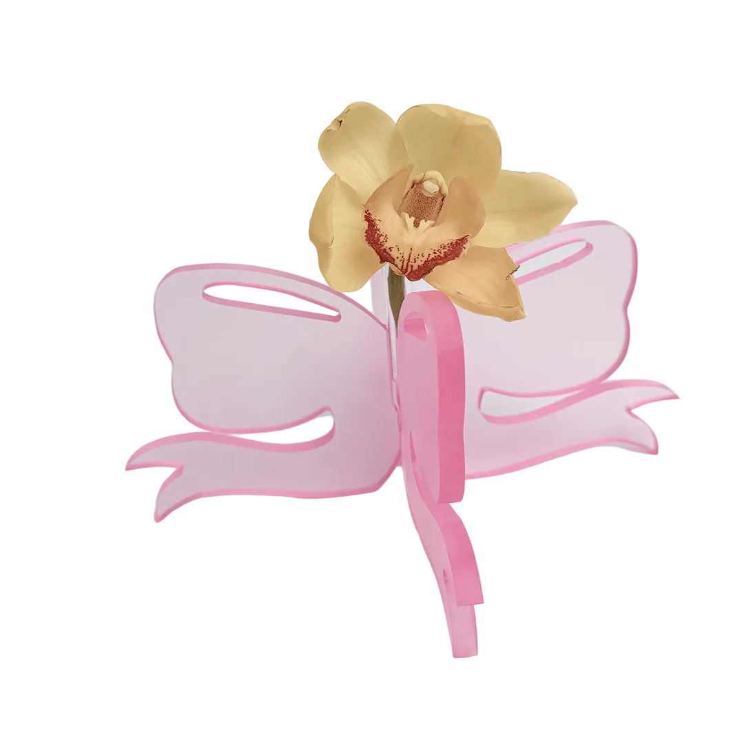 Pink butterfly-shaped clip with a yellow flower on a white background