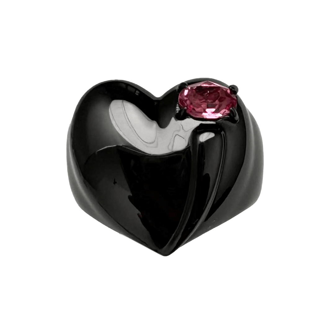 Wide band ring with a heart-shaped design and a pink Swarovski crystal centerpiece.