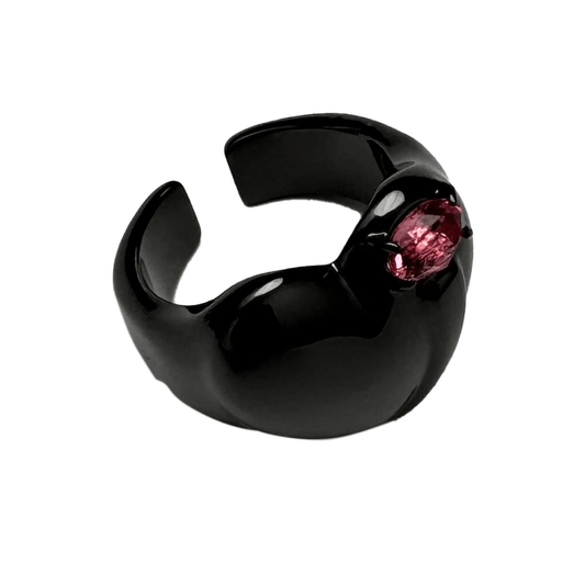 Wide band ring with a heart-shaped design and a pink Swarovski crystal centerpiece.