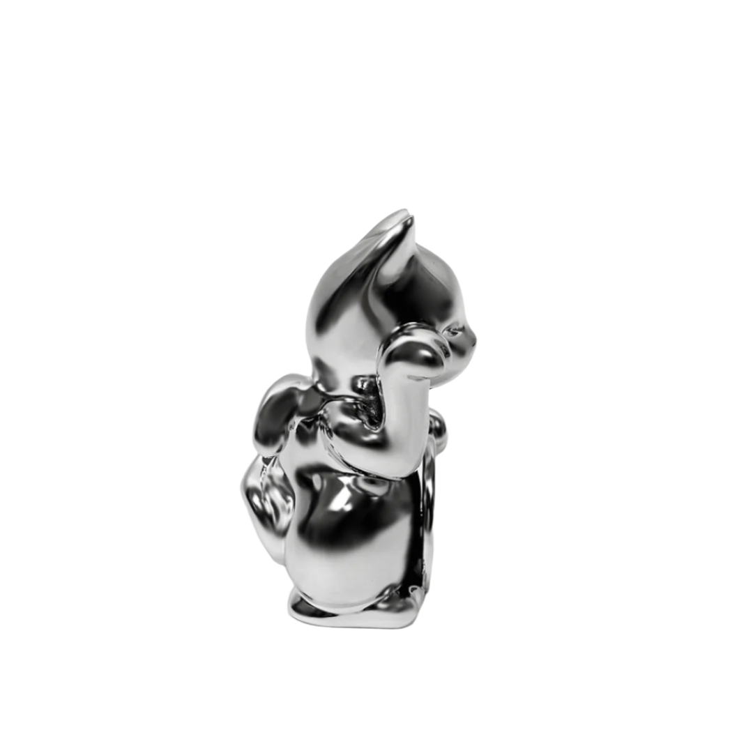 Futuristic chrome Maneki-neko sculpture – reflective silver lucky cat figure with raised paw and coin, blending traditional symbolism with modern minimalist form