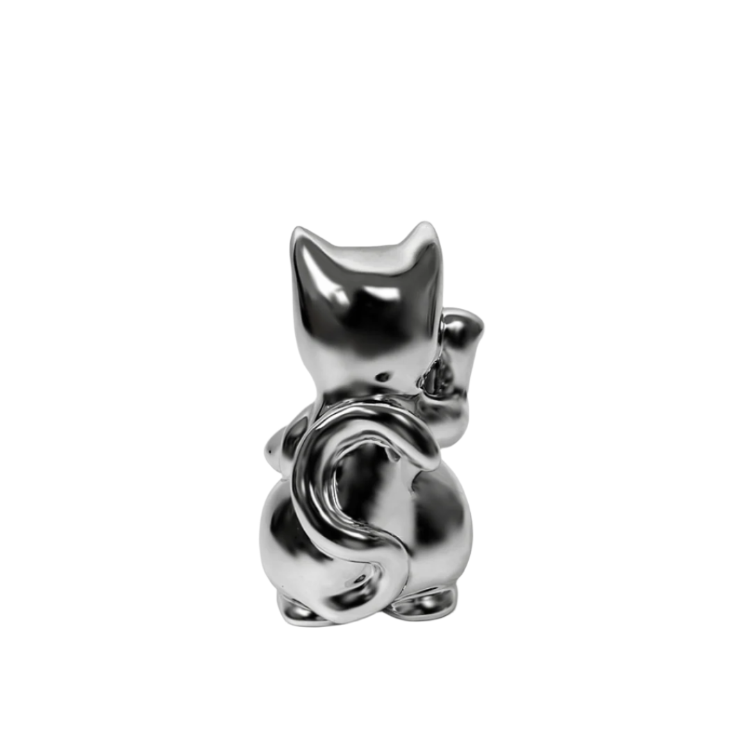 Futuristic chrome Maneki-neko sculpture – reflective silver lucky cat figure with raised paw and coin, blending traditional symbolism with modern minimalist form