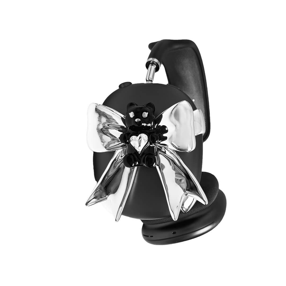 Transparent mirror phone case with a 3D teddy bear in brown flocking, wearing a black bow tie.