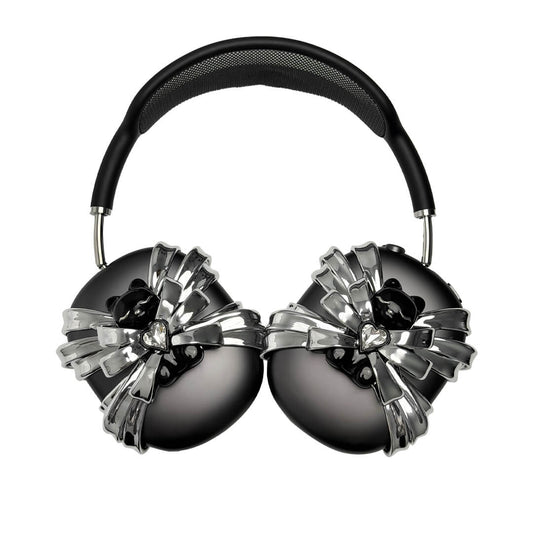 Ribbon Magic Bear AirPods Max cover featuring a glossy black bear holding a crystal heart, surrounded by layered metallic silver ribbons.