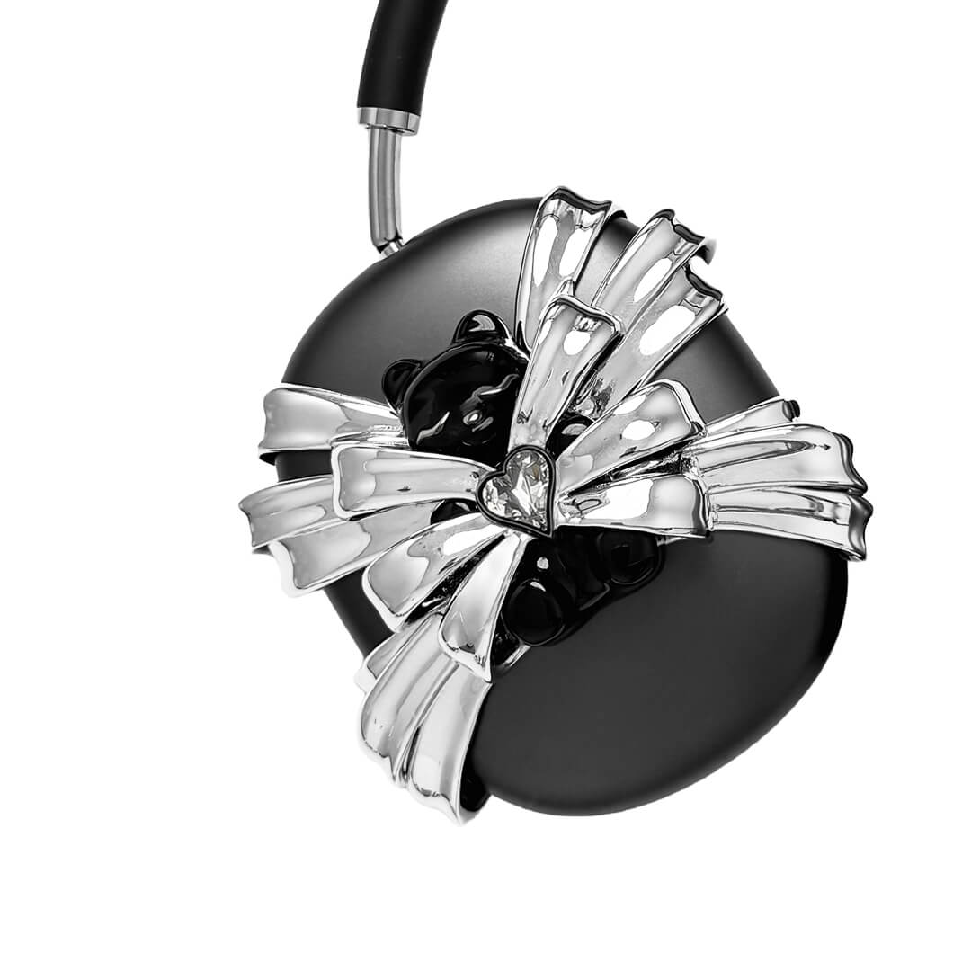 Ribbon Magic Bear AirPods Max cover featuring a glossy black bear holding a crystal heart, surrounded by layered metallic silver ribbons.