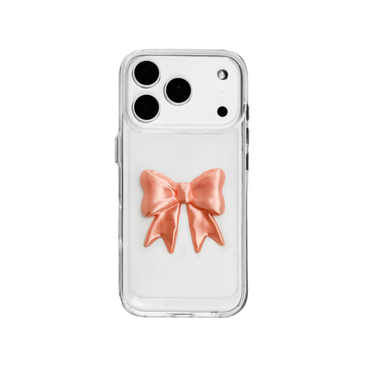 The Matte Bow iPhone Case S collection featuring the 3D sculpted matte bow in both Peach-Blush (Salmon Pink) and Classic White color variants, shown on both the Crystal Clear (Transparent) and White Leather Texture base options.