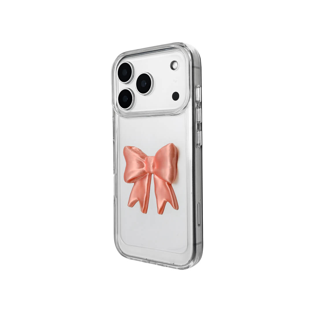 The Matte Bow iPhone Case S collection featuring the 3D sculpted matte bow in both Peach-Blush (Salmon Pink) and Classic White color variants, shown on both the Crystal Clear (Transparent) and White Leather Texture base options.