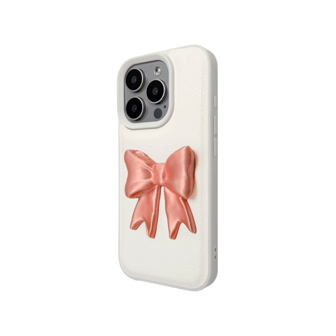 The Matte Bow iPhone Case S collection featuring the 3D sculpted matte bow in both Peach-Blush (Salmon Pink) and Classic White color variants, shown on both the Crystal Clear (Transparent) and White Leather Texture base options.