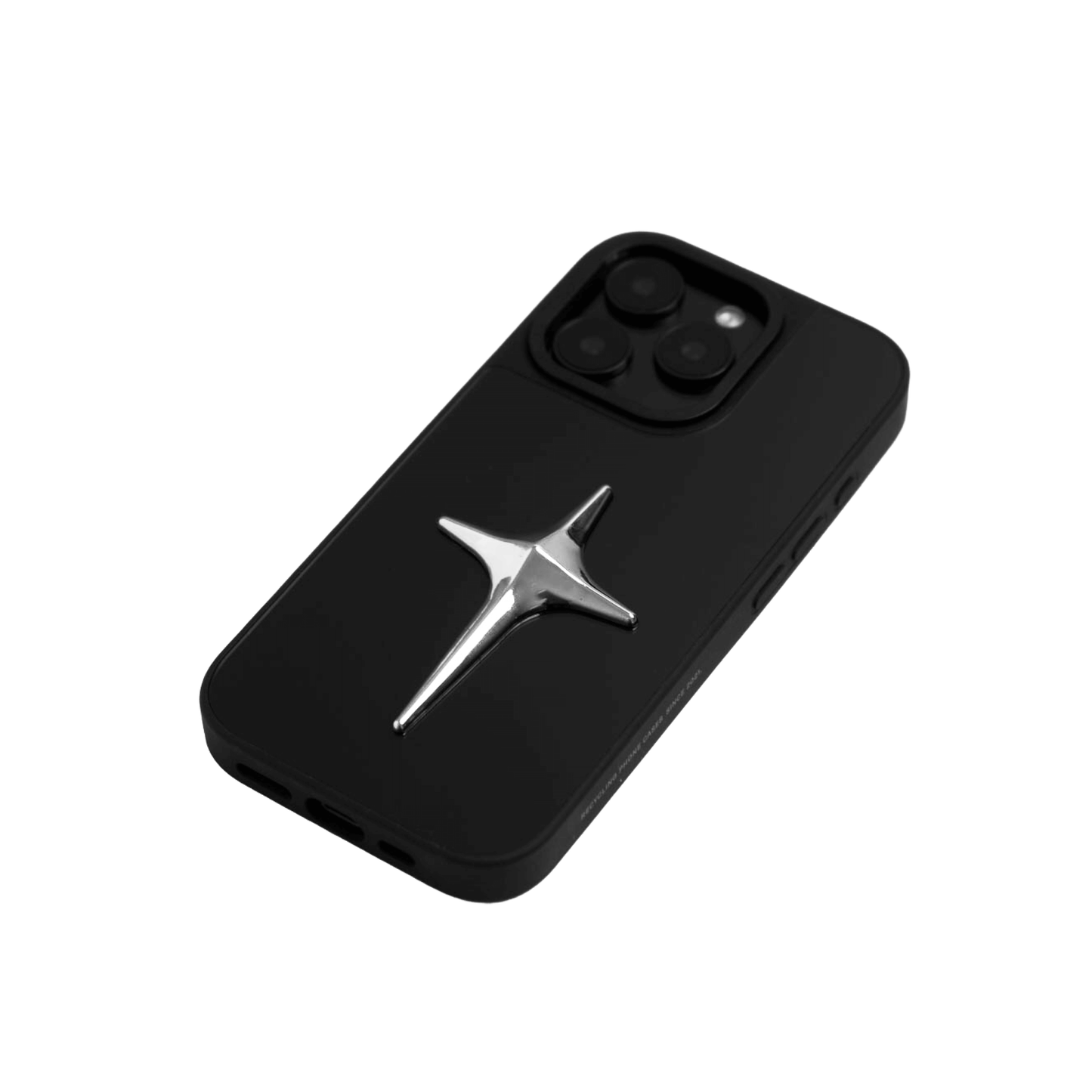 A collection of four black iPhone cases, each adorned with a distinct silver 3D metal emblem: a prominent bow tie, a sleek circular stud, an intricate spider, and a stylized four-point cross.