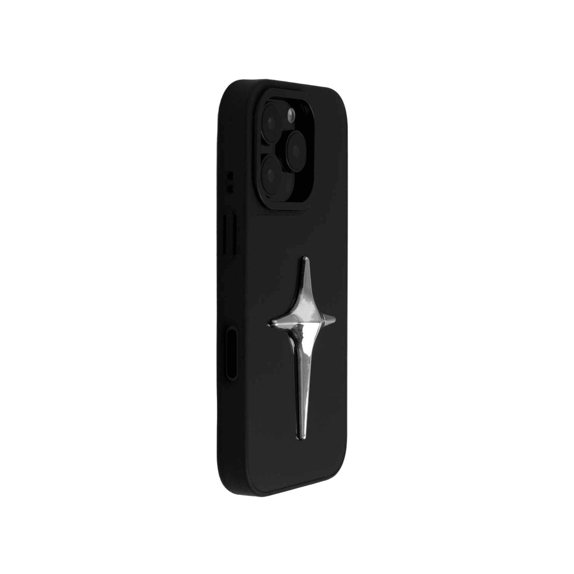 A collection of four black iPhone cases, each adorned with a distinct silver 3D metal emblem: a prominent bow tie, a sleek circular stud, an intricate spider, and a stylized four-point cross.