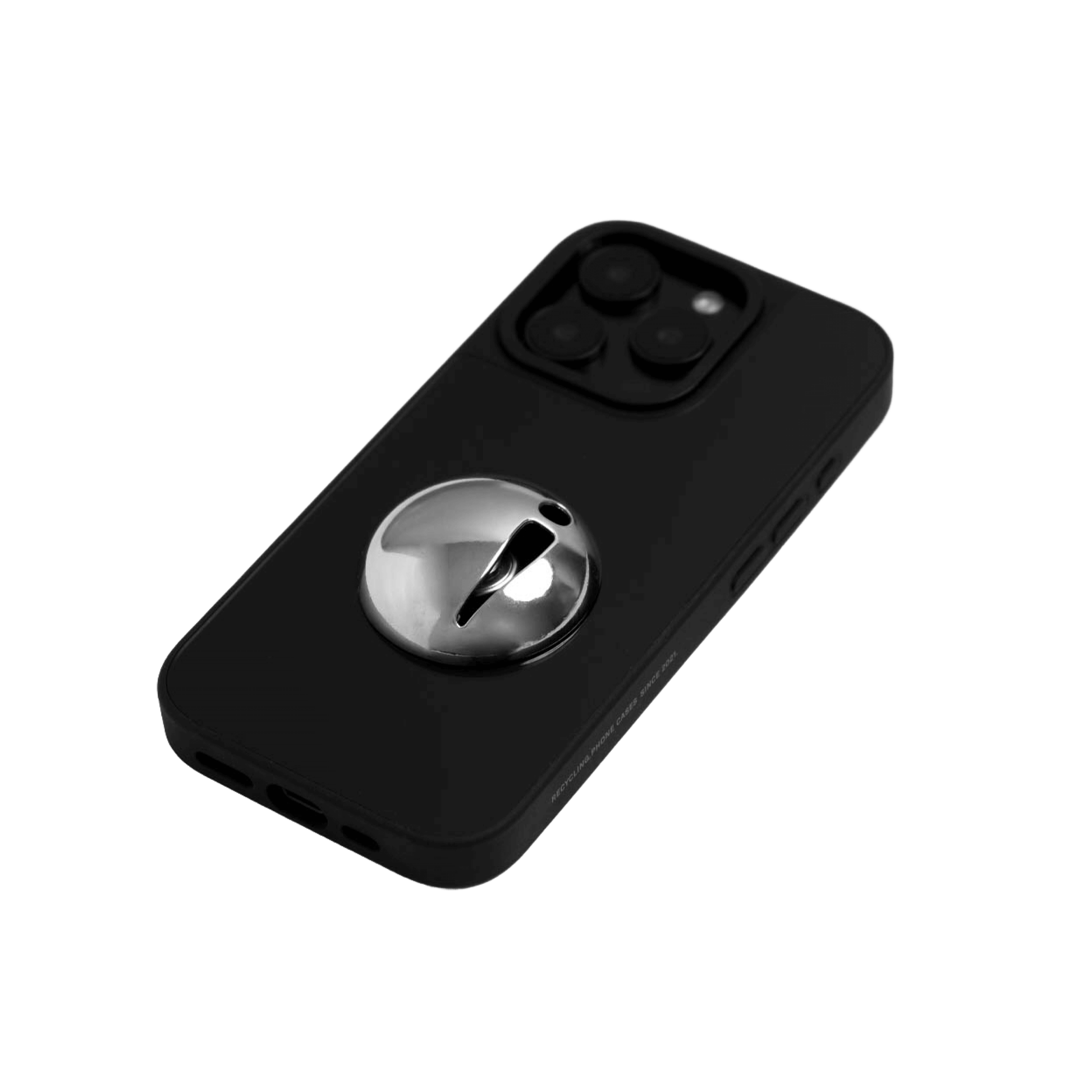 A collection of four black iPhone cases, each adorned with a distinct silver 3D metal emblem: a prominent bow tie, a sleek circular stud, an intricate spider, and a stylized four-point cross.