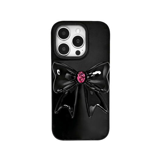 Midnight Gem Bow iPhone Case with 3D bow design, available in mirror silver and glossy black. Swarovski crystal centerpiece offered in black, white, or pink.