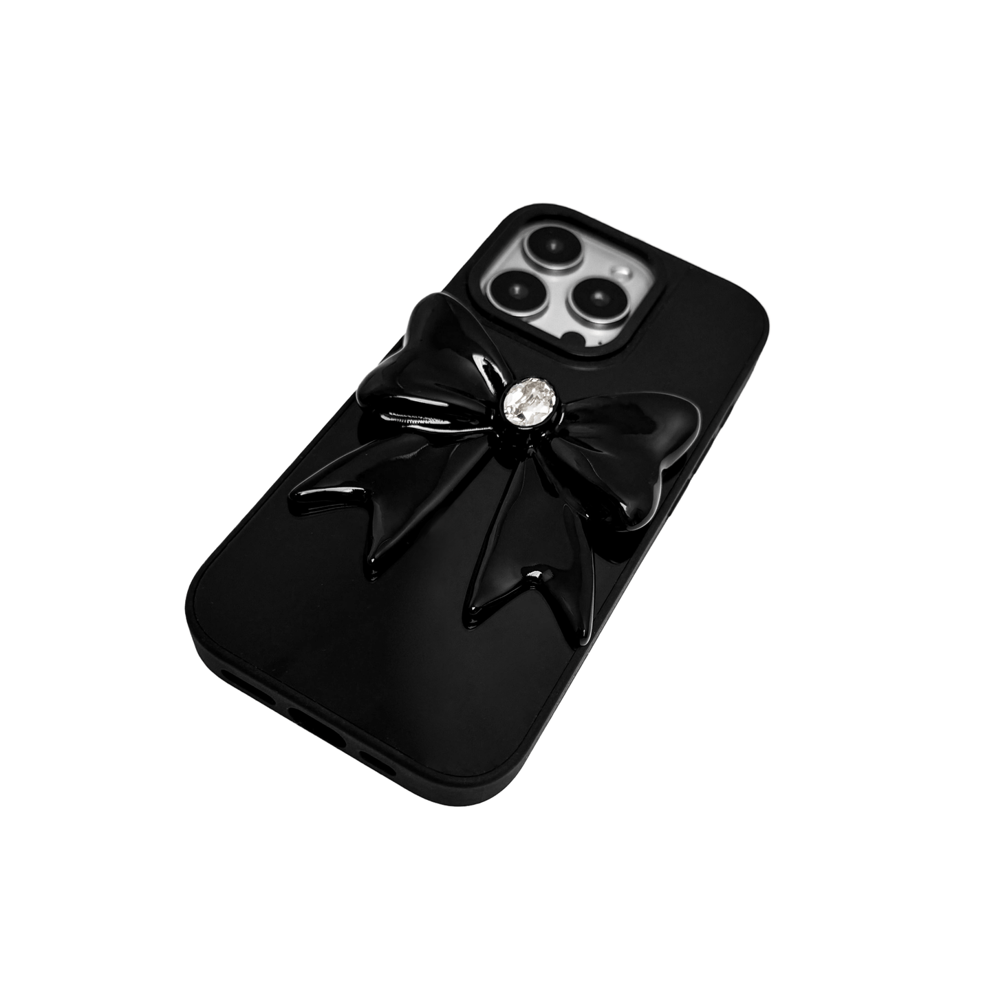 Midnight Gem Bow iPhone Case with 3D bow design, available in mirror silver and glossy black. Swarovski crystal centerpiece offered in black, white, or pink.