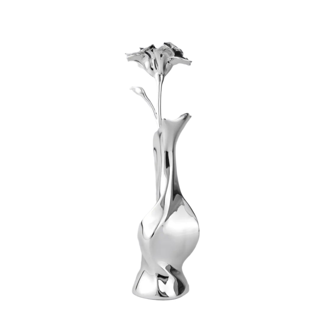 Futuristic chrome vase with fluid sculptural silhouette and blooming flower stem – high-shine metallic art object with organic elegance