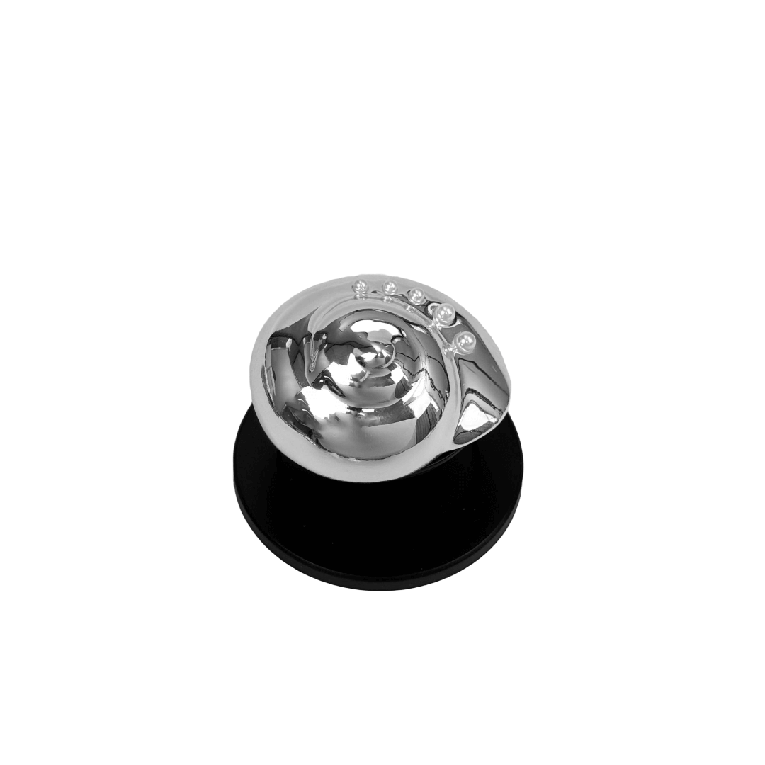 Glossy silver, white spiral shell phone grip with rhinestone accents – mounted on a matte black base and attached to a gray iPhone case