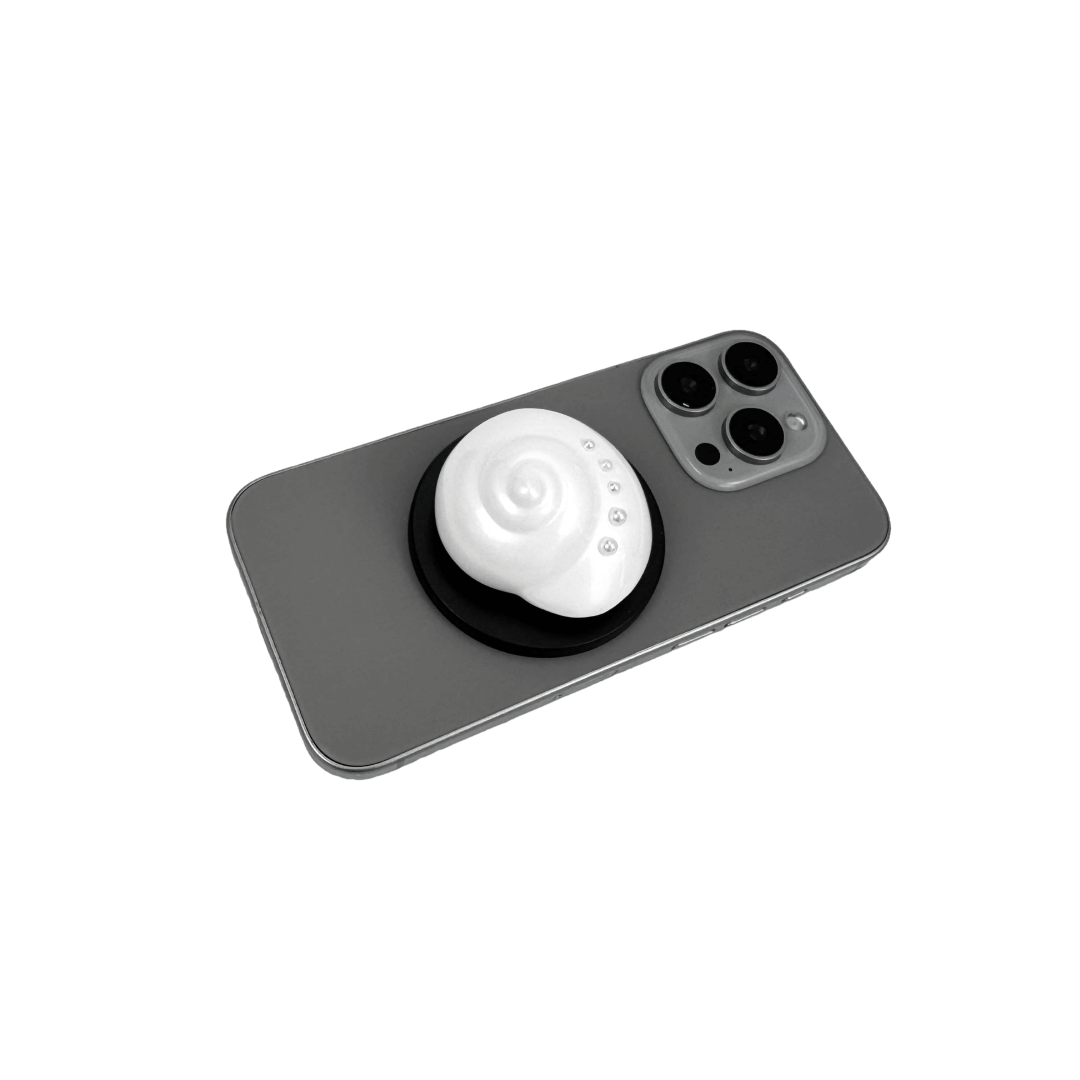 Glossy silver, white spiral shell phone grip with rhinestone accents – mounted on a matte black base and attached to a gray iPhone case