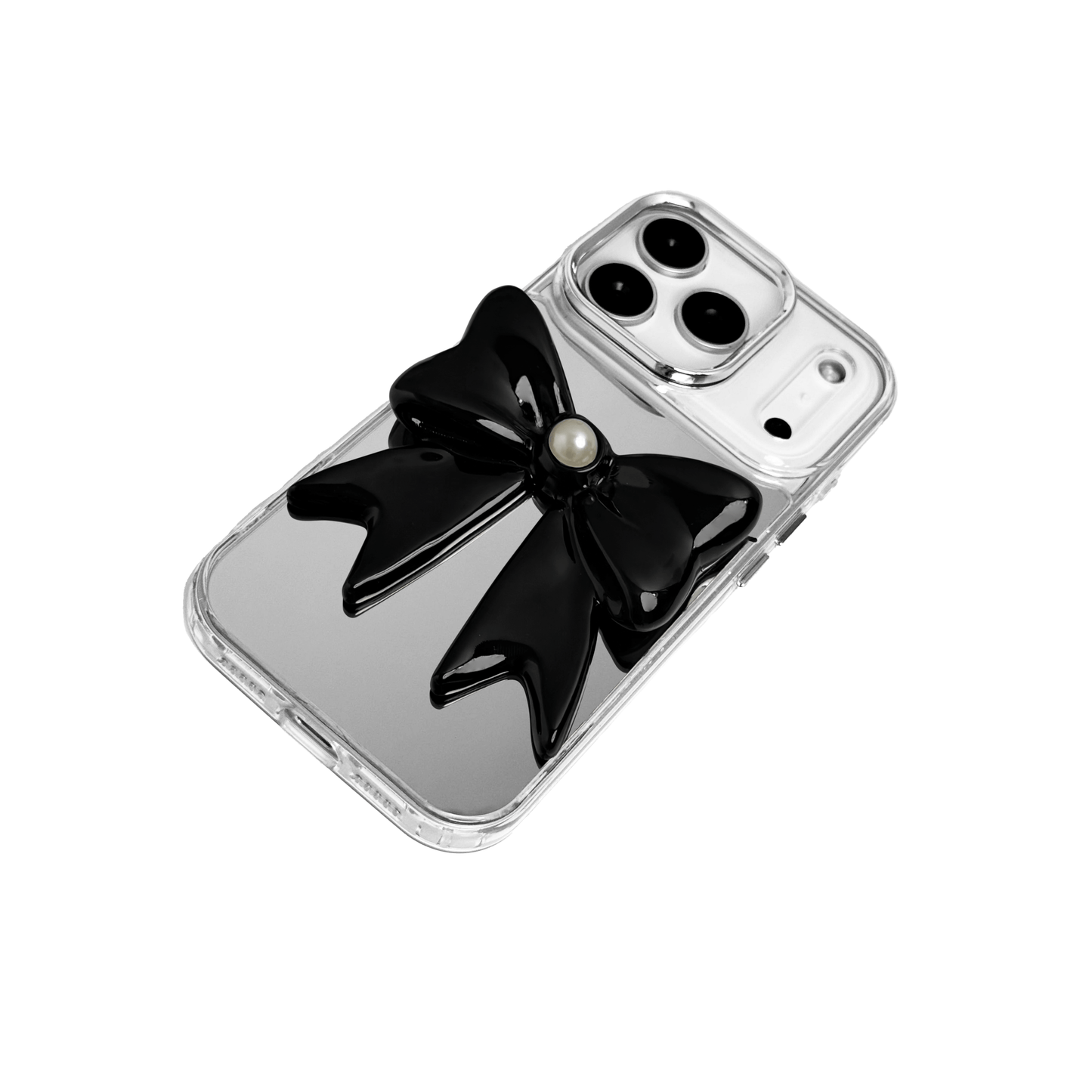 A set of two iPhone cases, both featuring a large, 3D bow charm centered on the back. One case shows a black bow and the other a white bow, with a single white pearl embedded at the center of each bow. The phone cases appear to have a silver or transparent base.