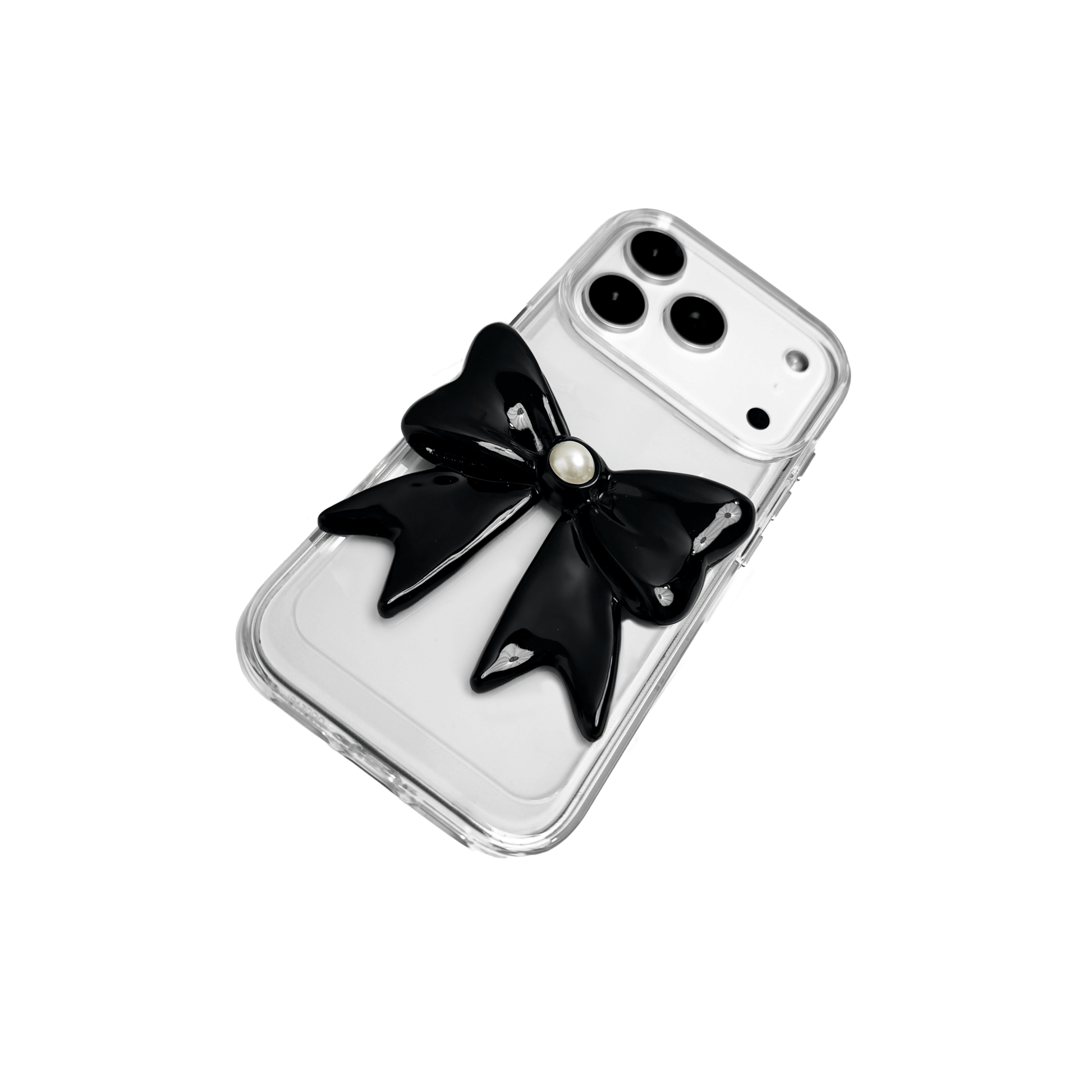 A set of two iPhone cases, both featuring a large, 3D bow charm centered on the back. One case shows a black bow and the other a white bow, with a single white pearl embedded at the center of each bow. The phone cases appear to have a silver or transparent base.